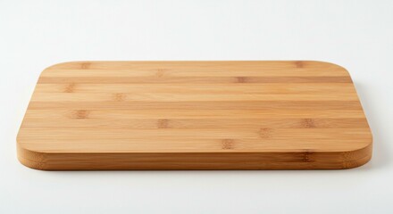 A bamboo cutting board on a white surface, perfect for culinary creations.