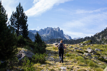 Young hiker woman in Vall de Boi, Aiguestortes and Sant Maurici National Park, Spain