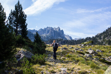 Naklejka premium Young hiker woman in Vall de Boi, Aiguestortes and Sant Maurici National Park, Spain