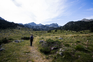 Young hiker woman in Vall de Boi, Aiguestortes and Sant Maurici National Park, Spain