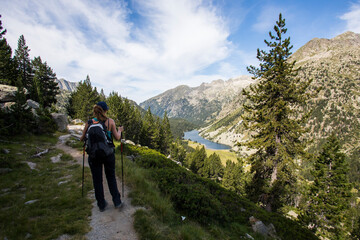 Young hiker woman in Vall de Boi, Aiguestortes and Sant Maurici National Park, Spain