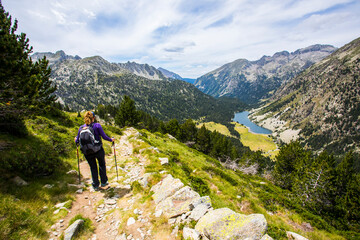 Young hiker woman in Vall de Boi, Aiguestortes and Sant Maurici National Park, Spain