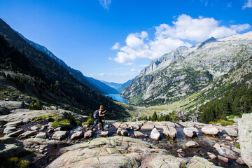 Young hiker woman in Vall de Boi, Aiguestortes and Sant Maurici National Park, Spain