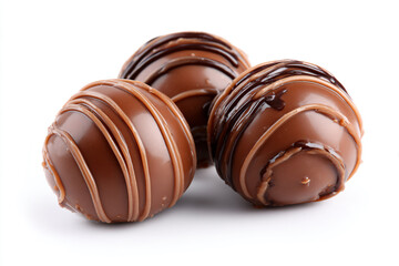 Obraz premium three chocolate covered donuts on a white surface