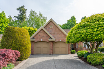 Garage door in luxury house with trees and nice landscape in Spring in Vancouver, Canada, North...