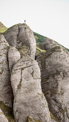 silhouette of a man on a rock cliff