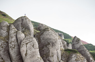 silhouette of a man on a rock cliff