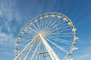 Ferris Wheel Against Clear Blue Sky, Perfect for Travel, Amusement Park Ads, Summer Fun, Adventure Vibes, and Scenic Backgrounds in Tourism Campaigns