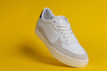 Stylish White Sneaker Floating on Yellow Background – Modern Footwear Design, Fashion Concept, Minimalist Product Photography