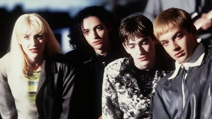 Portrait of 1990s alternative rock band members in moody lighting