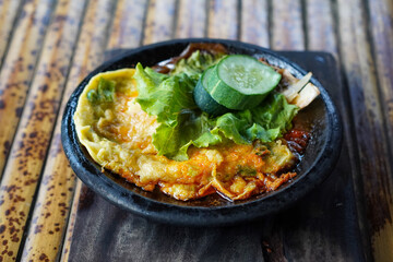 Sambal Gami, Indonesia, captured on June 9, 2025. Traditional spicy chili sauce served on a hot clay plate, made with fresh chilies, garlic, tomatoes, and shrimp paste for bold and smoky flavor.