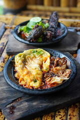 Sambal Gami, Indonesia, captured on June 9, 2025. Traditional spicy chili sauce served on a hot clay plate, made with fresh chilies, garlic, tomatoes, and shrimp paste for bold and smoky flavor.
