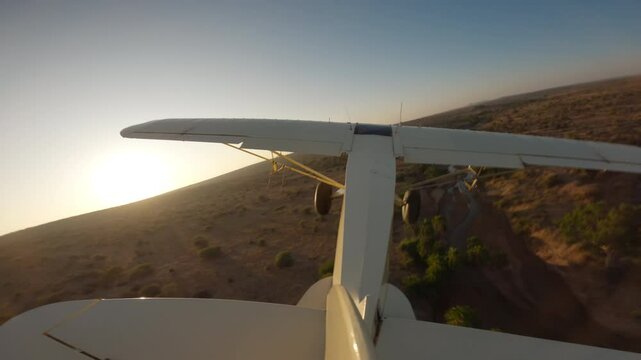 Extreme wide tail view of a bushcraft plane flying over two rivers in the savanna at kenya