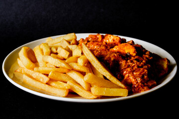  A Plate of Traditional Chicken Tikka Masala With Chips