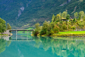 Obraz premium Lakeside Serenity – Scenic House at Oldevatnet, Bridge in Olden, Norway