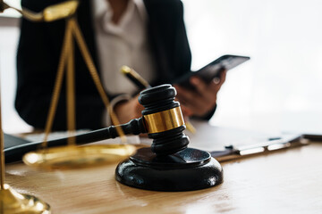 A professional lawyer advises a client in a legal office, reviewing contracts and justice symbols...