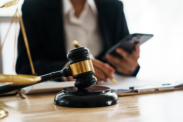 A professional lawyer advises a client in a legal office, reviewing contracts and justice symbols...