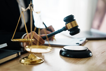 A professional lawyer advises a client in a legal office, reviewing contracts and justice symbols...