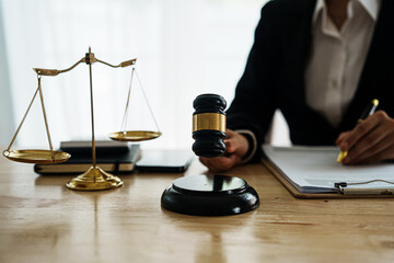 A professional lawyer advises a client in a legal office, reviewing contracts and justice symbols...