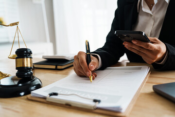 A professional lawyer advises a client in a legal office, reviewing contracts and justice symbols...