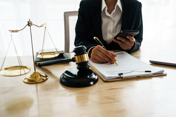 A professional lawyer advises a client in a legal office, reviewing contracts and justice symbols...