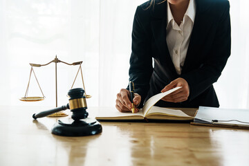 A professional lawyer advises a client in a legal office, reviewing contracts and justice symbols...