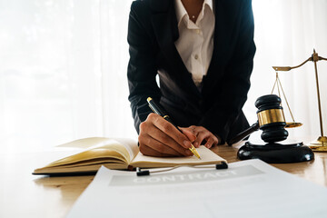 A professional lawyer advises a client in a legal office, reviewing contracts and justice symbols...