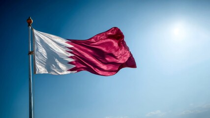 Qatar's national flag proudly waving on independence day under a clear blue sky
