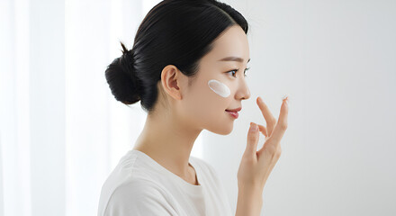 Woman applying facial cream (8)
