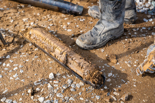 Fresh soil core sample placed on the ground after drilling. Subsurface material collected for geotechnical testing and laboratory analysis