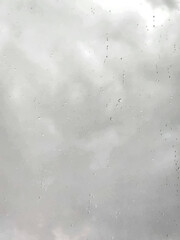 A gray day, as rain hits a window