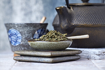Dried Green Tea Leaves on Bright Background. Close up.	