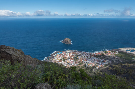 Aerial view of old town Garachico from Mirador de Garachico view point. Colorful houses and harbor. Ocean shore with lava rock pools. Popular tourist destination, Tenerife Canary Islands.