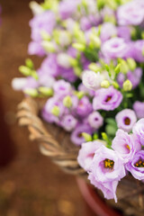 Closeup of a basket full of purple lisianthus flowers