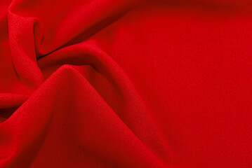 The background of the banner for the site from a piece of fabric. Texture of silk or satin fabric in red color. Textile