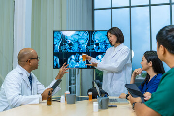 Group of professional doctors engaged in a discussion or meeting in a medical office. A large...