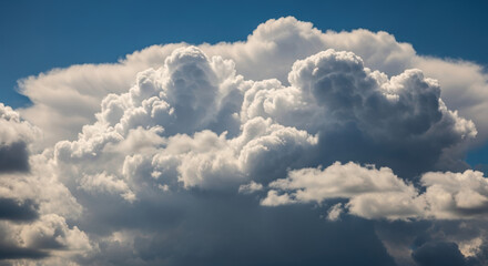 Bright White Fluffy Clouds in Blue Sky with Sunlight Creating Shadows and Highlights