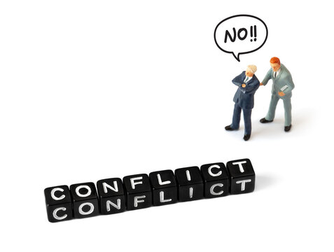 Two opposing businessmen arguing on white background. One crosses his arms and says No. Black letter blocks spelling "Conflict" on a white background. Conflict or discussion in business world - Powered by Adobe