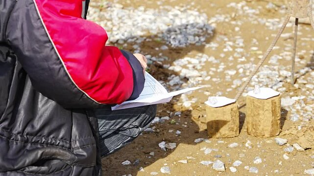 Engineer recording data from extracted soil samples on construction site. Documentation of geotechnical observations for analysis and foundation planning