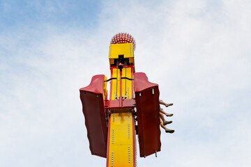 attraction falling tower with people sitting in the seat. bottom view