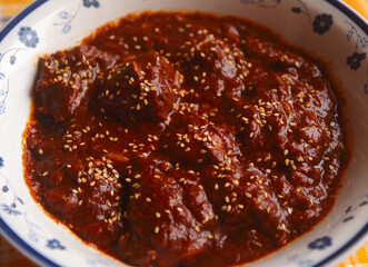 Chicken in spicy chocolate Mole Poblano sauce - famous typical Mexican dish from Puebla, Mexico. Selective focus