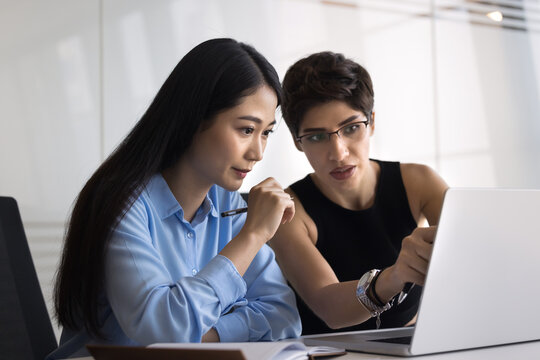 Armenian mentor and Chinese apprentice review new software, planning strategy, discuss goals or next steps for online project, using new tools or internet resources. Feedback or guidance, mentorship