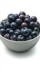 Juicy, plump blueberries piled high in a simple bowl create an appealing visual for healthy eating, dessert inspiration, or fresh fruit marketing. Ideal for culinary uses.