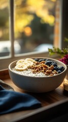 Warm bowl of quinoa porridge topped with banana and blueberries  