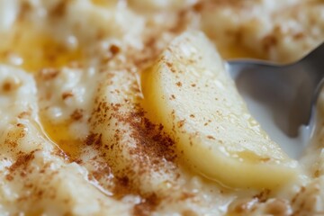Close-up of creamy oatmeal with banana and cinnamon drizzle  