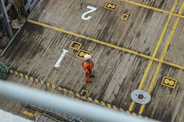 The seaman is waiting for beginning of the deck cargo operations on board of the offshore support...