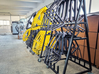 Production line of painted bicycle frames arranged on a rack in a factory