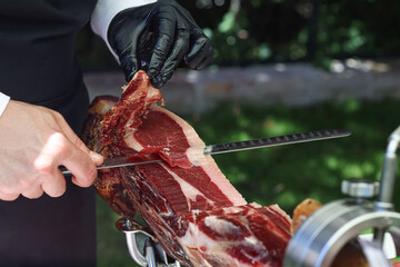 Traditional cut of Iberian ham with a knife