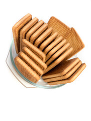 Cookies in a glass plate on a white background.