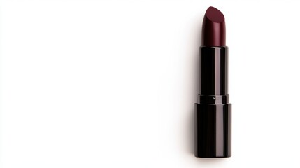 Obraz premium A close-up of a dark burgundy lipstick, elegantly positioned on a white background, suitable for beauty marketing, blogs, or product reviews highlighting makeup essentials,